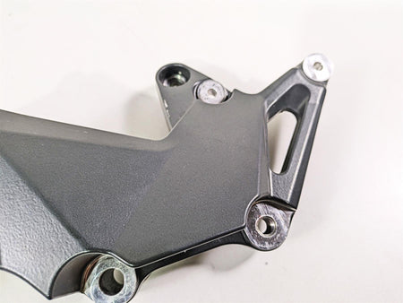 Used motorcycle footpeg bracket metal part on white background, available at Mototech271