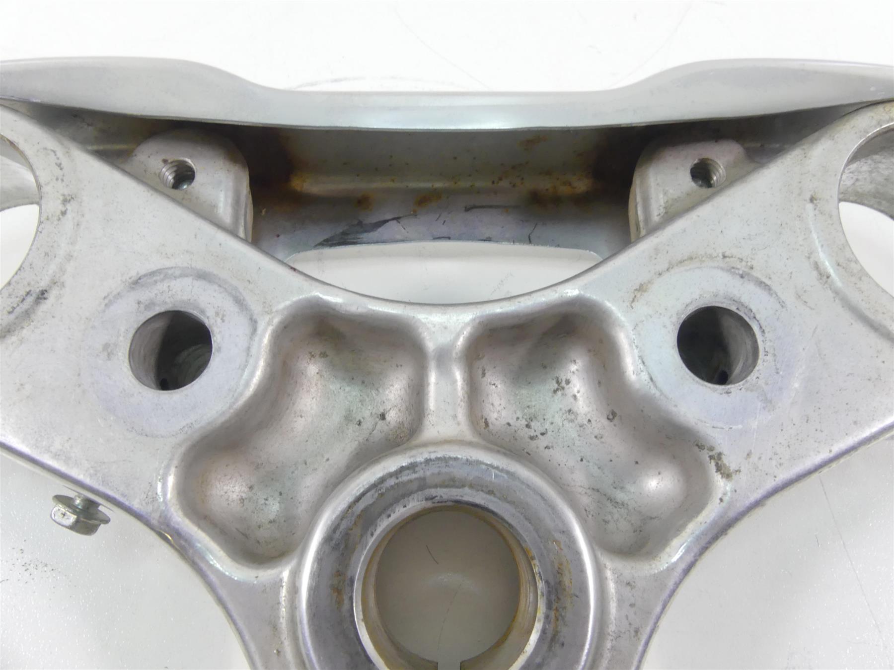 Used silver motorcycle upper triple clamp with mounting holes and slight wear, available at Mototech271