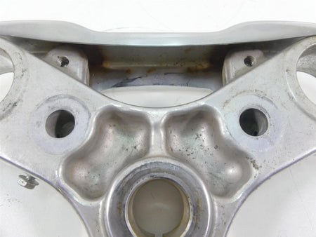 Used silver motorcycle upper triple clamp with mounting holes and slight wear, available at Mototech271