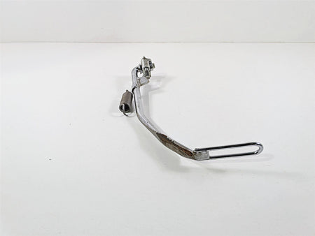 Used chrome motorcycle brake pedal with spring on white background, available at Mototech271