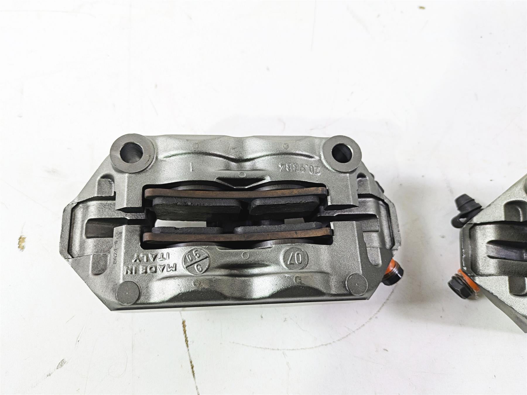 Used motorcycle brake caliper with brake pads on white background, available at Mototech271