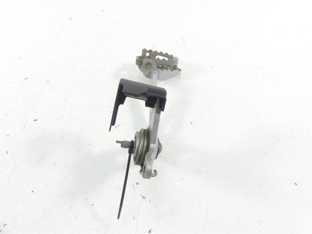 Used motorcycle foot peg assembly with bracket and spring, available at Mototech271