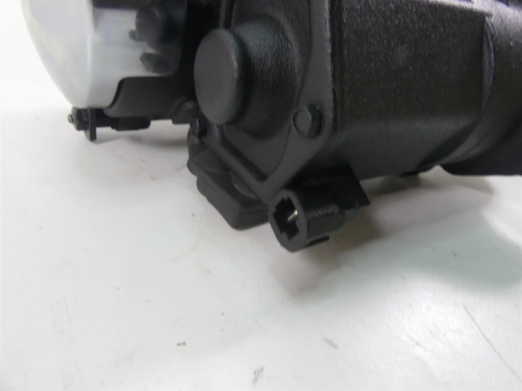 Close-up of used black motorcycle part with connector plug, available at Mototech271