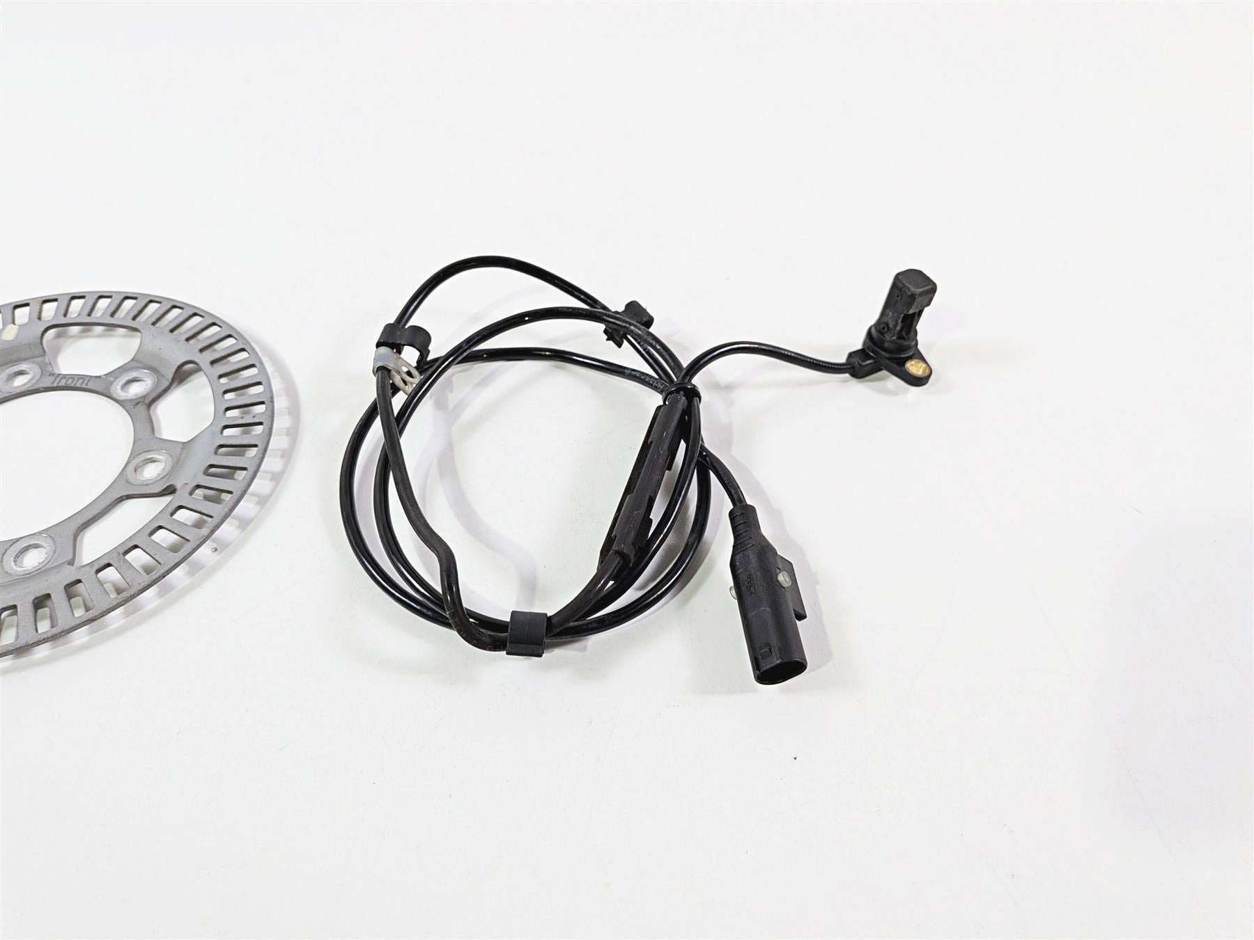 Used motorcycle ABS sensor cable and brake rotor on white background, available at Mototech271