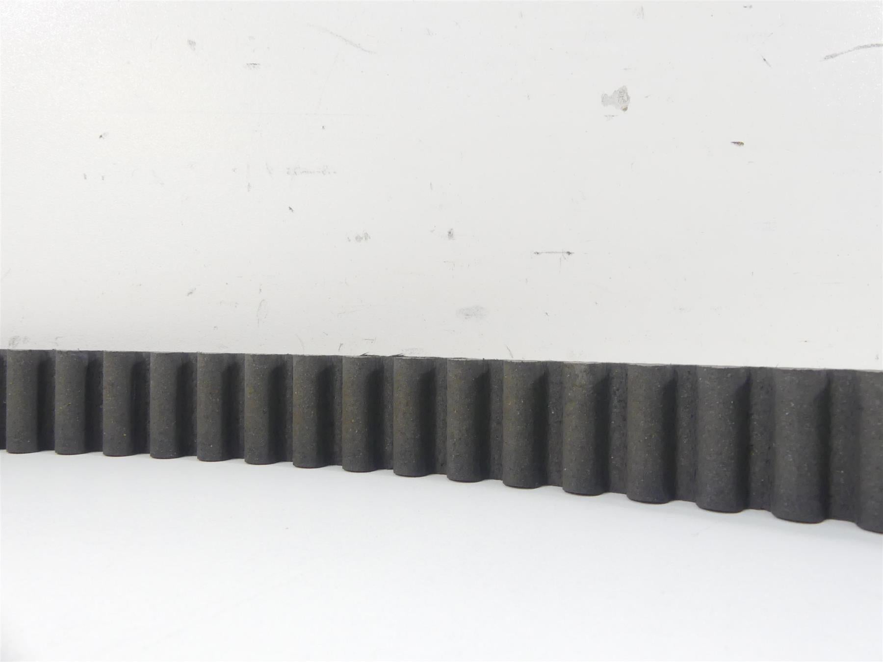 Close-up of used motorcycle drive belt with teeth, available at Mototech271