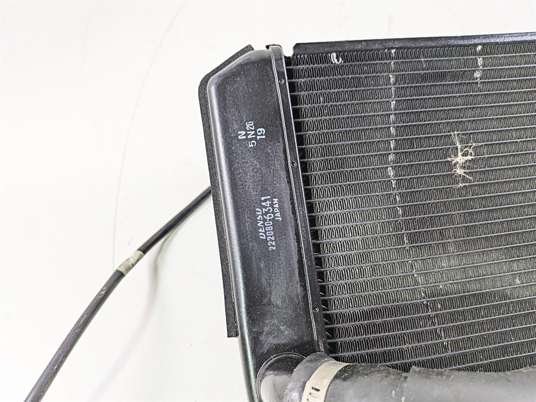 Used motorcycle radiator with cooling fins and attached hose available at Mototech271