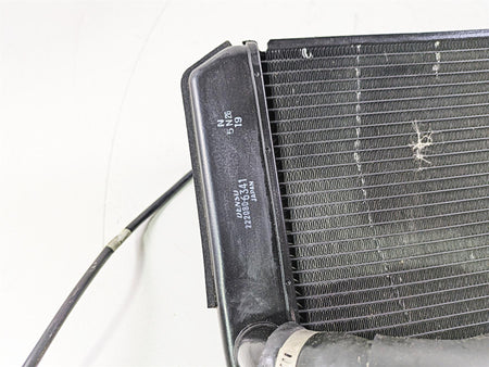 Used motorcycle radiator with cooling fins and attached hose available at Mototech271