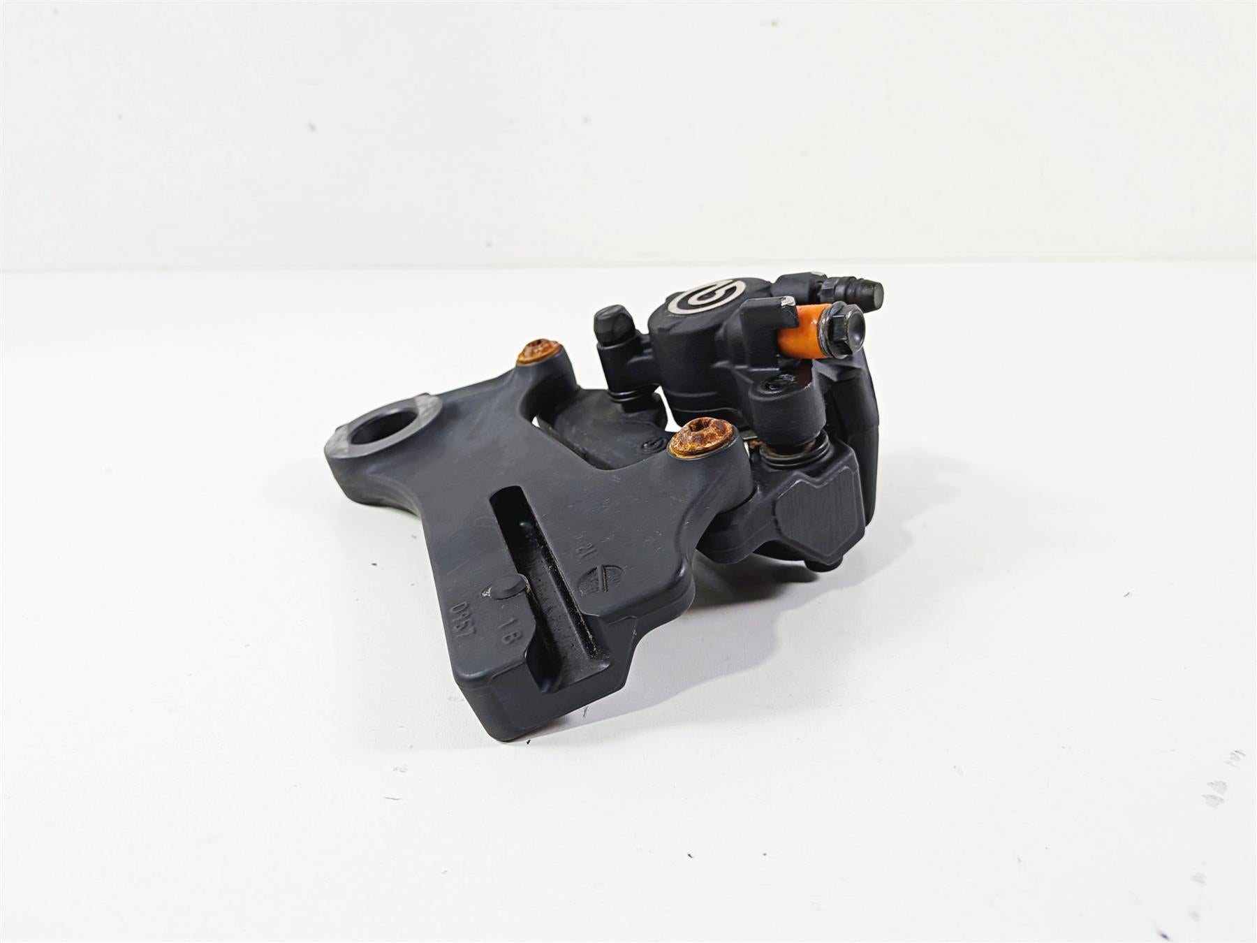 Used black motorcycle brake caliper part on white background, available at Mototech271