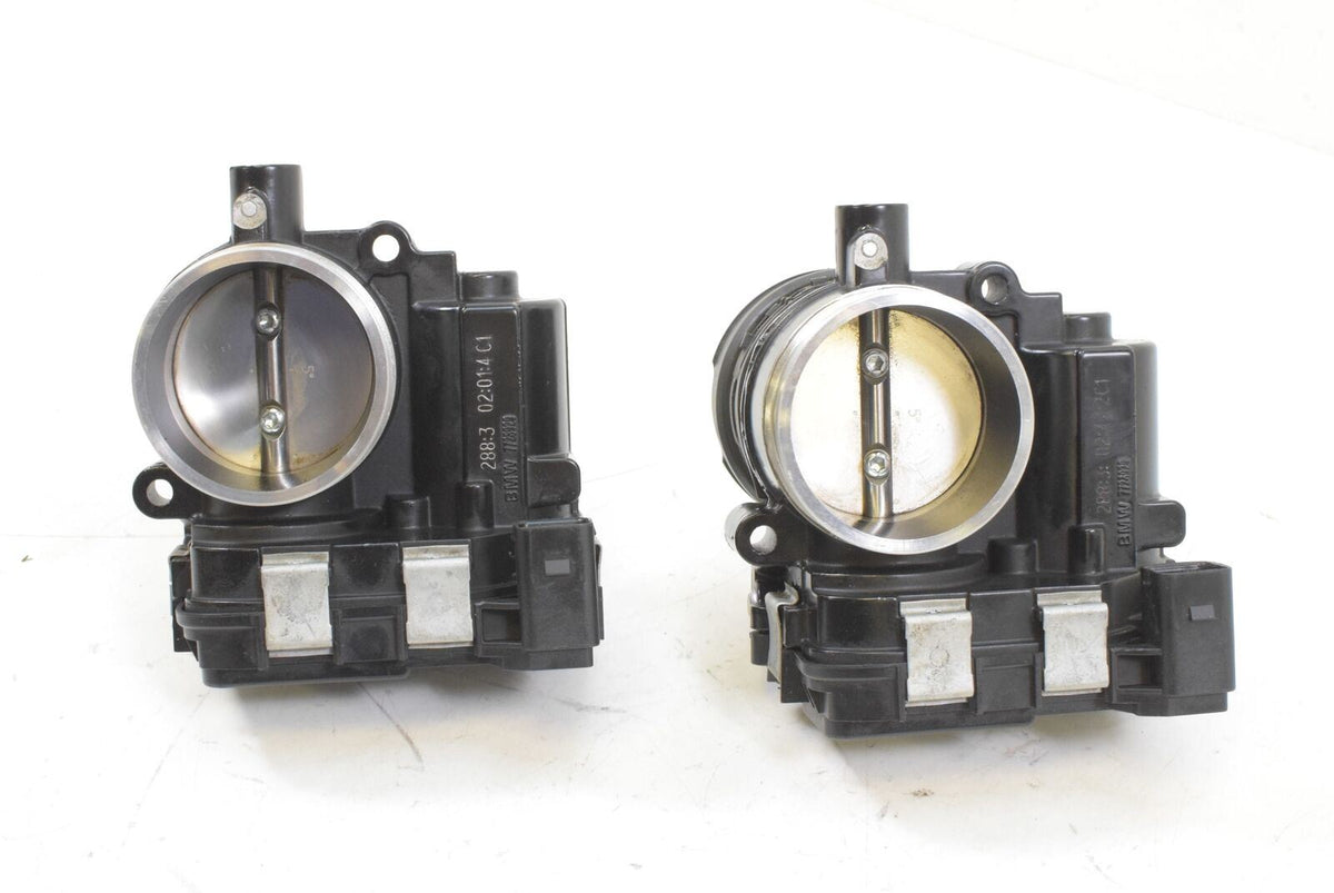 Pair of used motorcycle throttle bodies on white background, available at Mototech271