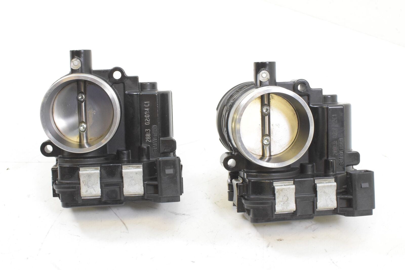 Pair of used motorcycle throttle bodies on white background, available at Mototech271