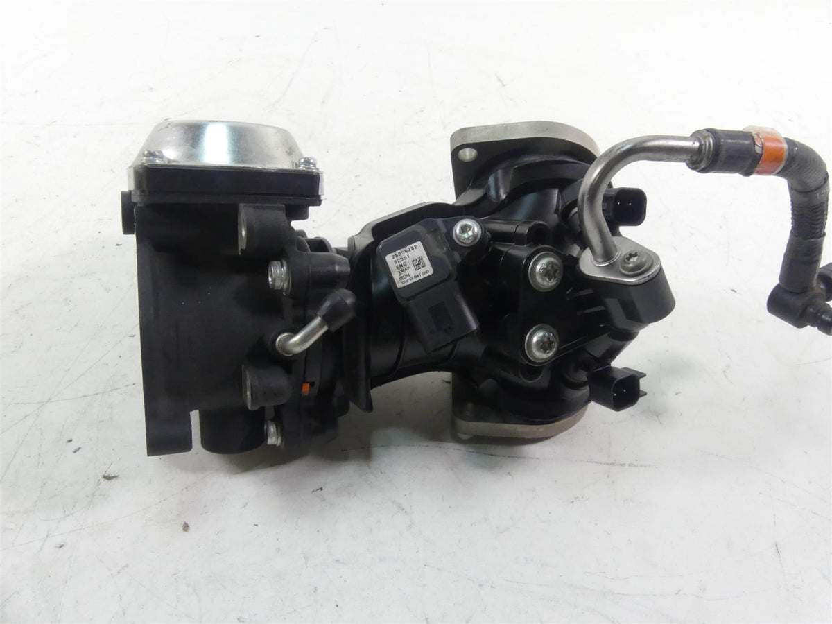 Used motorcycle throttle body with attached wiring and metal hose on white background, available at Mototech271
