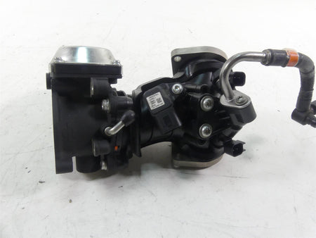 Used motorcycle throttle body with attached wiring and metal hose on white background, available at Mototech271