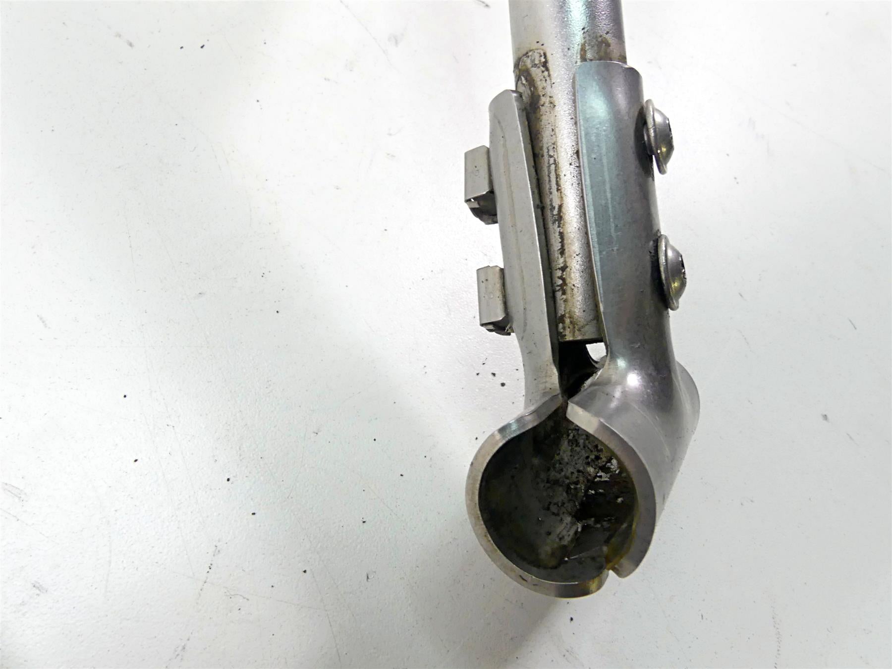 Used motorcycle handlebar clamp with bolts on white background, available at Mototech271