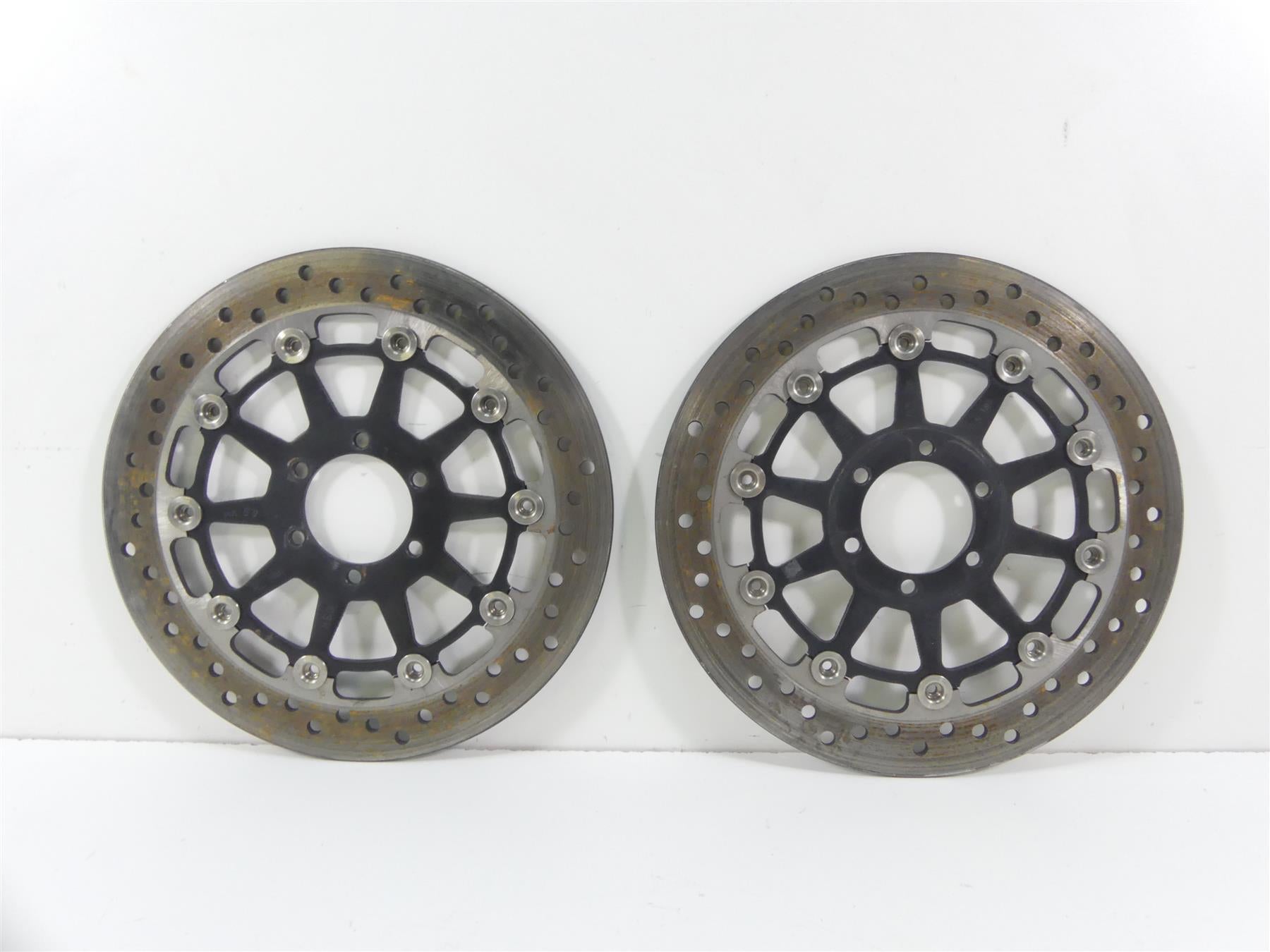 Pair of used motorcycle front brake rotors with drilled design on white background, available at Mototech271