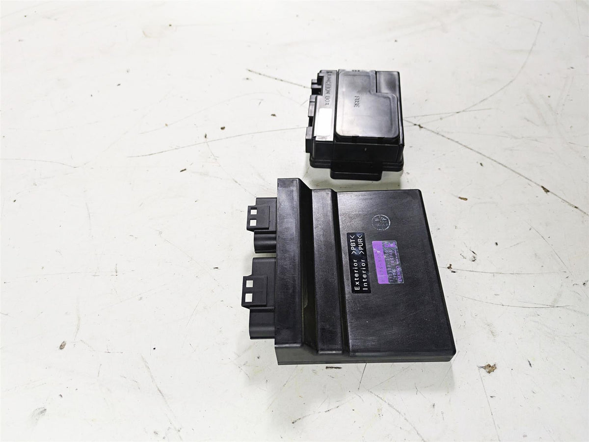 Two used black motorcycle ECU control modules on a white background, available at Mototech271