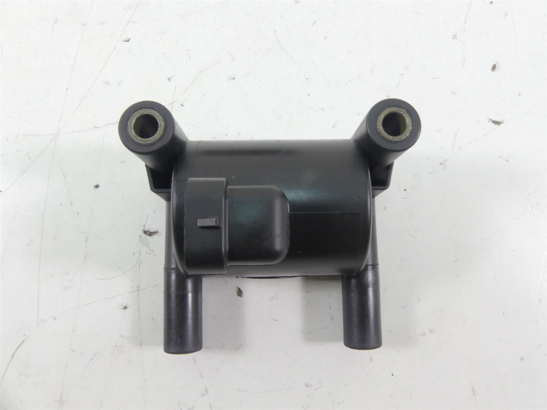 Used motorcycle ignition coil on white background, available at Mototech271