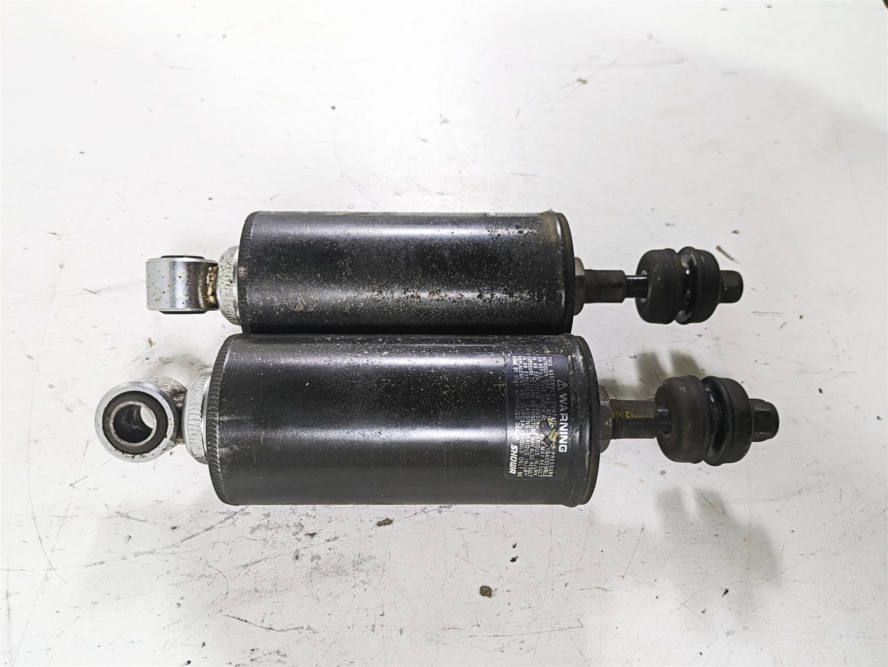 Used black motorcycle shock absorbers on white background, available at Mototech271