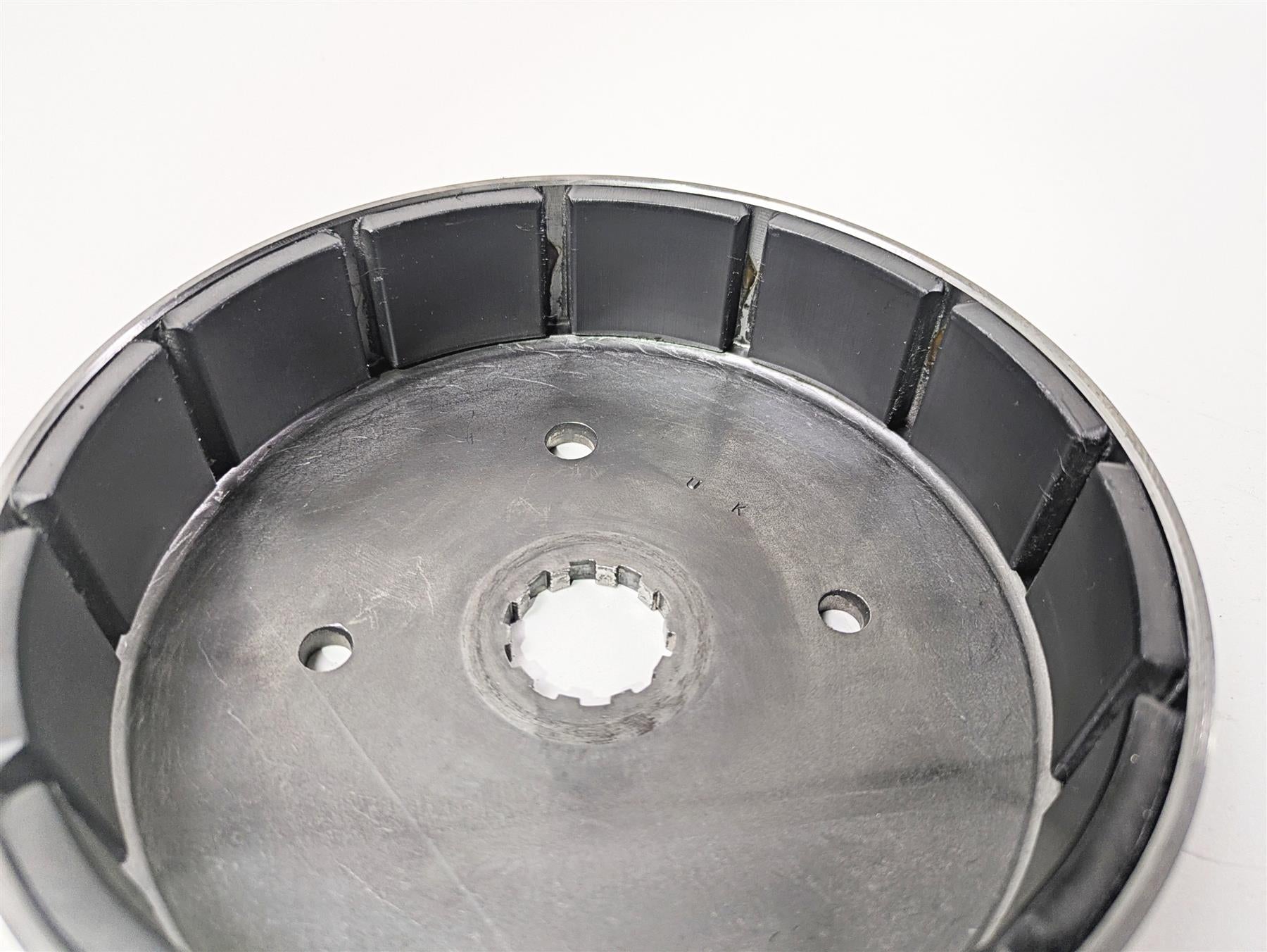Used motorcycle clutch drum with mounting holes and splined center, available at Mototech271
