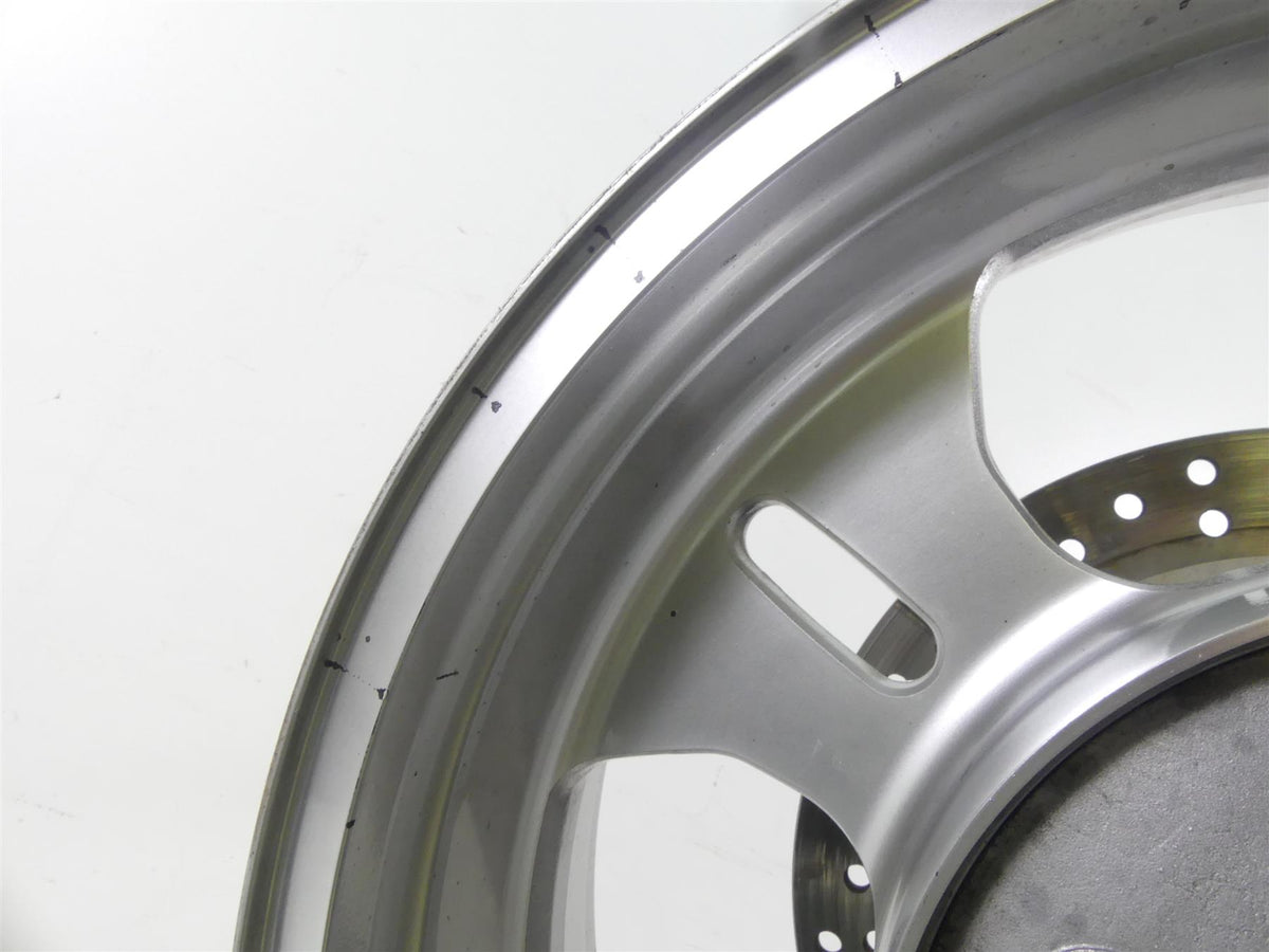 Close-up of used silver motorcycle wheel rim with vent slots, available at Mototech271