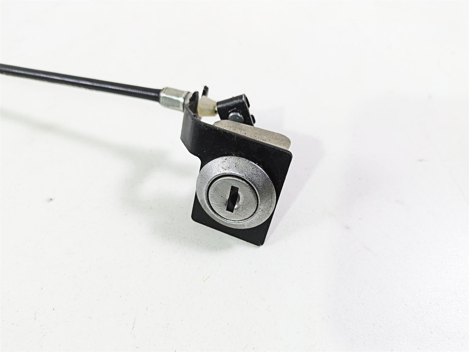 motorcycle seat lock assembly with cable on white background, available at Mototech271