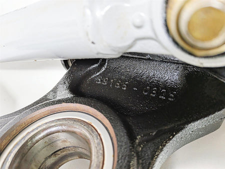 Close-up of used motorcycle suspension linkage with bearing and part number, available at Mototech271