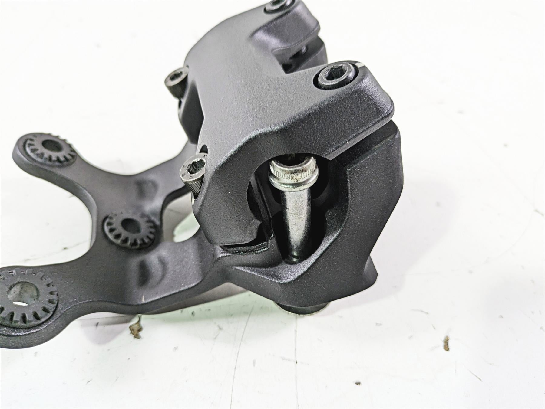 Used black motorcycle brake caliper with mounting bracket on white background, available at Mototech271