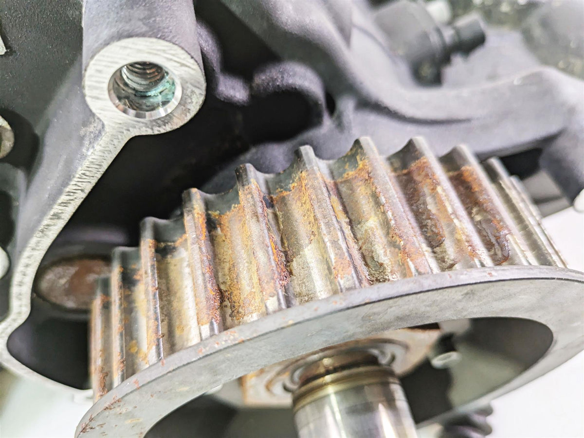 Close-up of a used motorcycle engine timing gear with visible rust, available at Mototech271