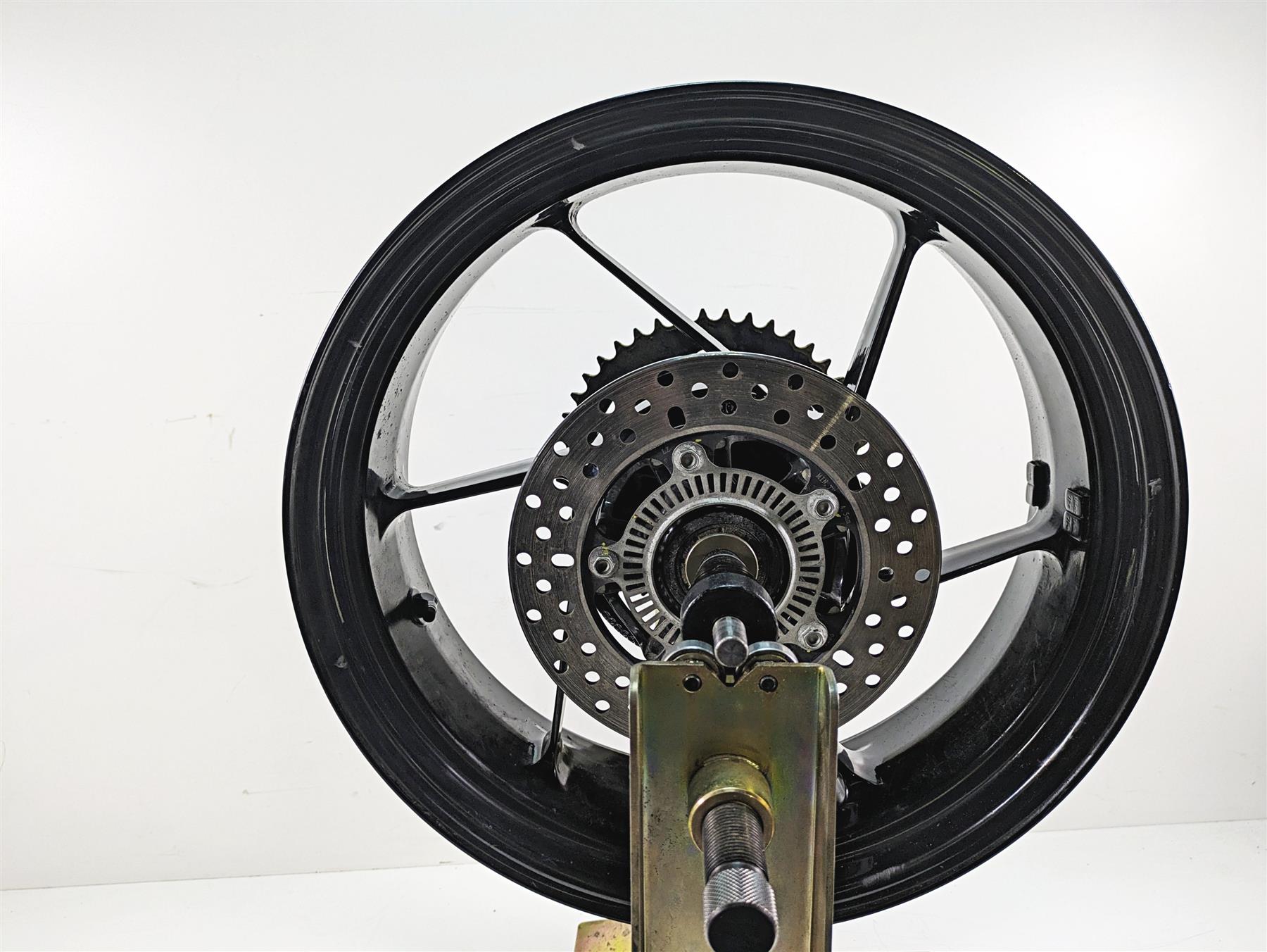 Used motorcycle rear wheel with brake disc and sprocket on a white background, available at Mototech271