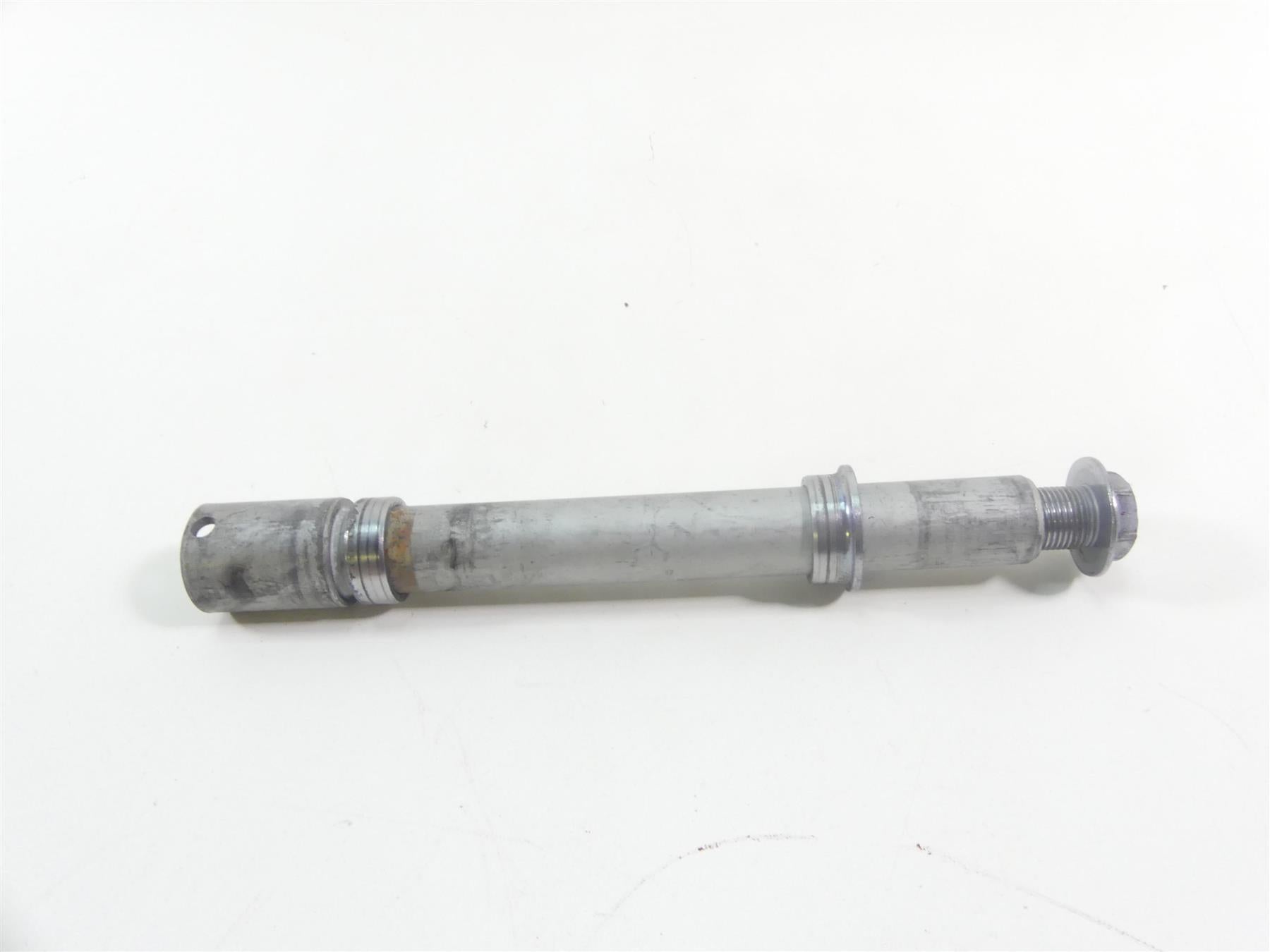 Used motorcycle front axle part on white background, available at Mototech271