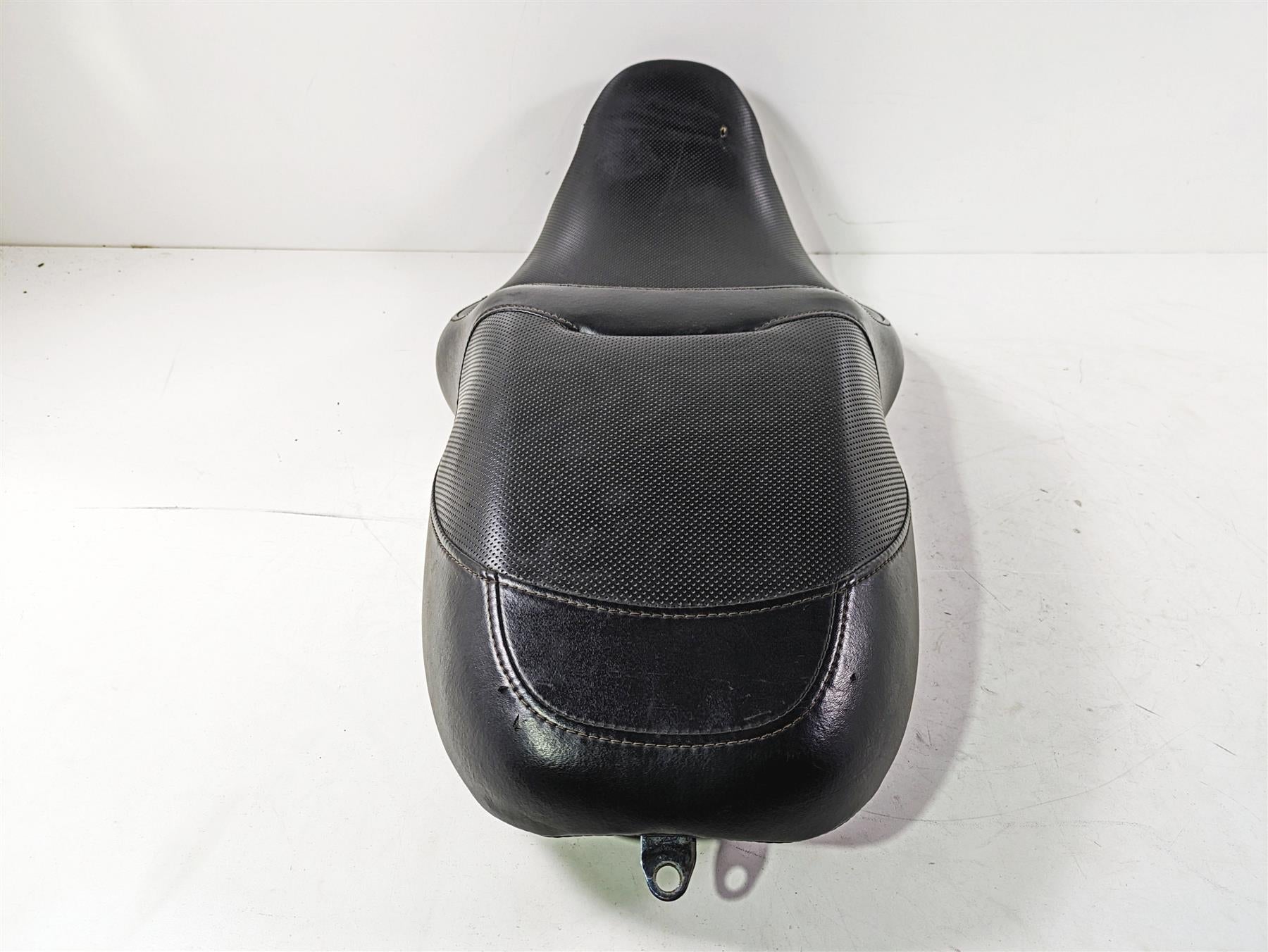 used black motorcycle seat with textured surface on white background, available at Mototech271