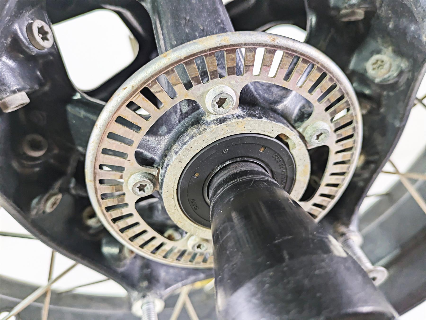 Close-up of a used motorcycle wheel hub with ABS tone ring, available at Mototech271