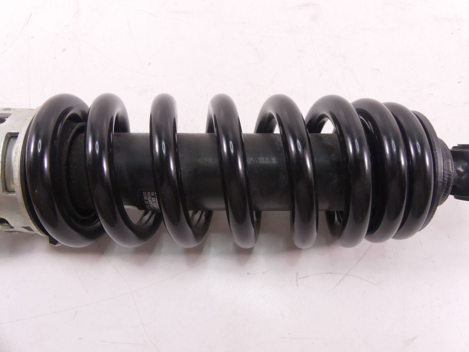 Black motorcycle shock absorber coil spring close-up, available at Mototech271