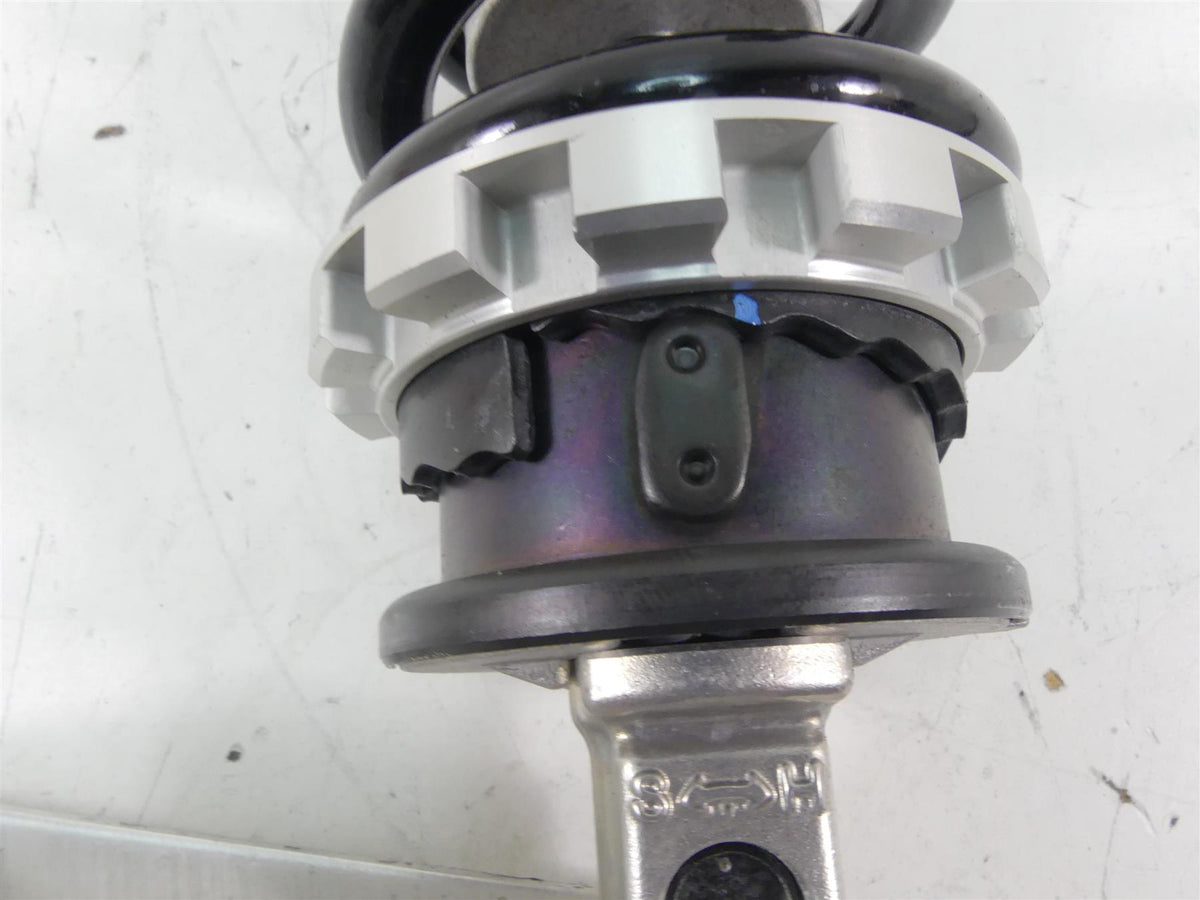 Close-up of a used motorcycle shock absorber coil spring on white background, available at Mototech271
