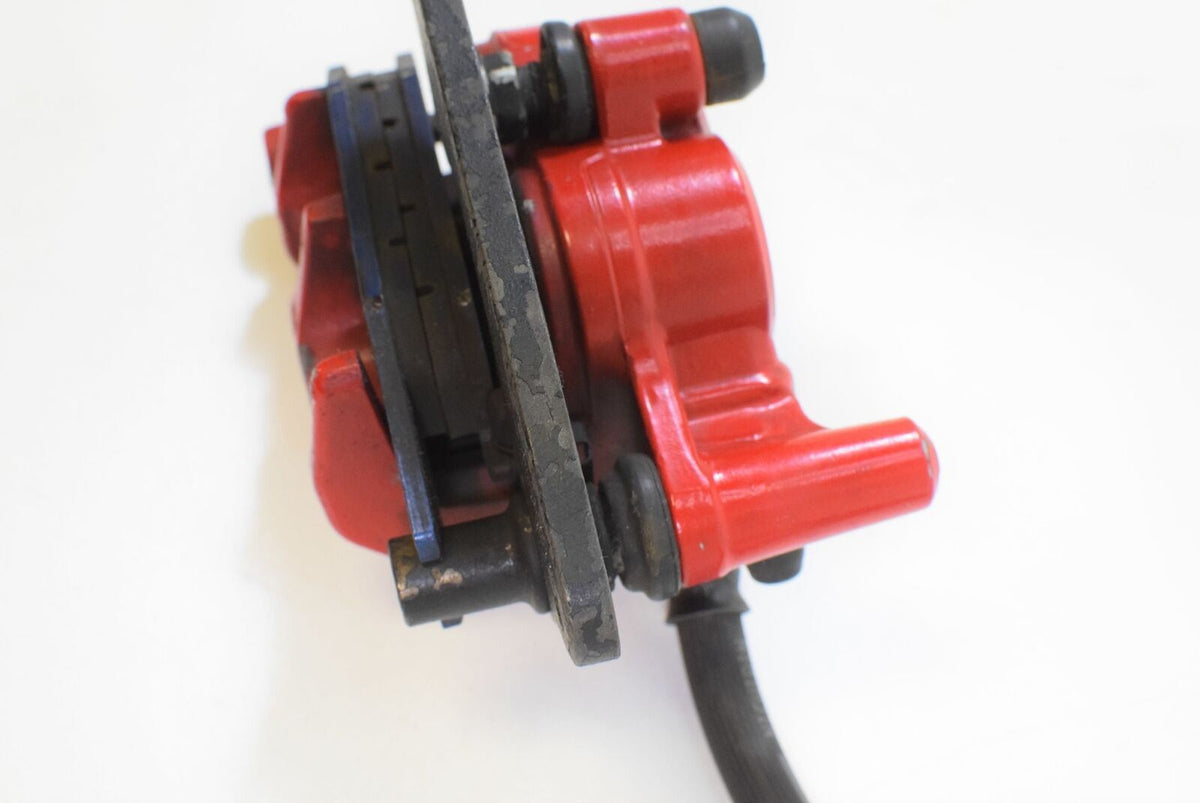 Used red motorcycle brake caliper with disc, available at Mototech271