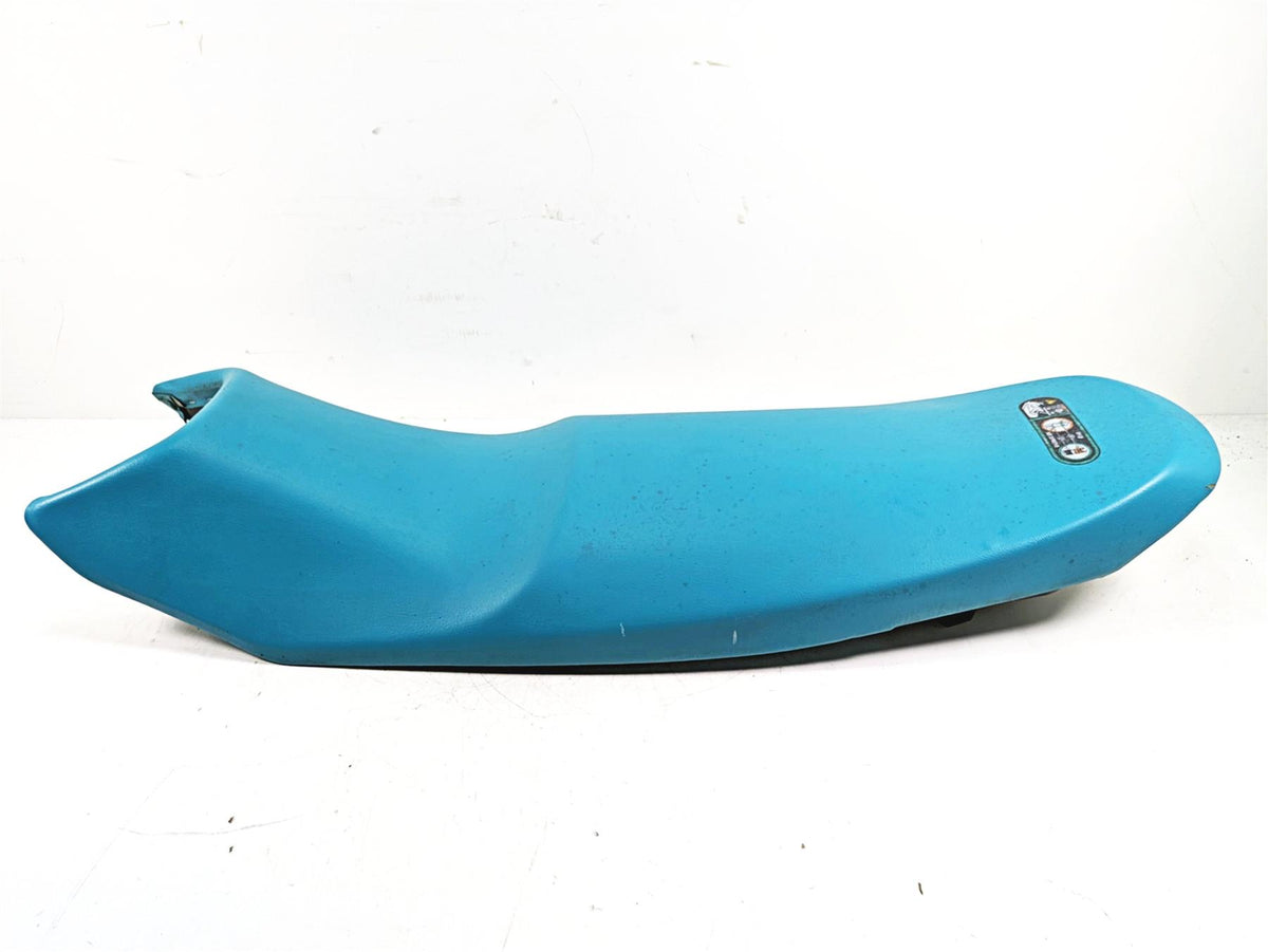 Blue used motorcycle seat part with label on top, available at Mototech271