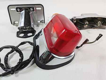 Used motorcycle tail light assembly with chrome housing and wiring, available at Mototech271