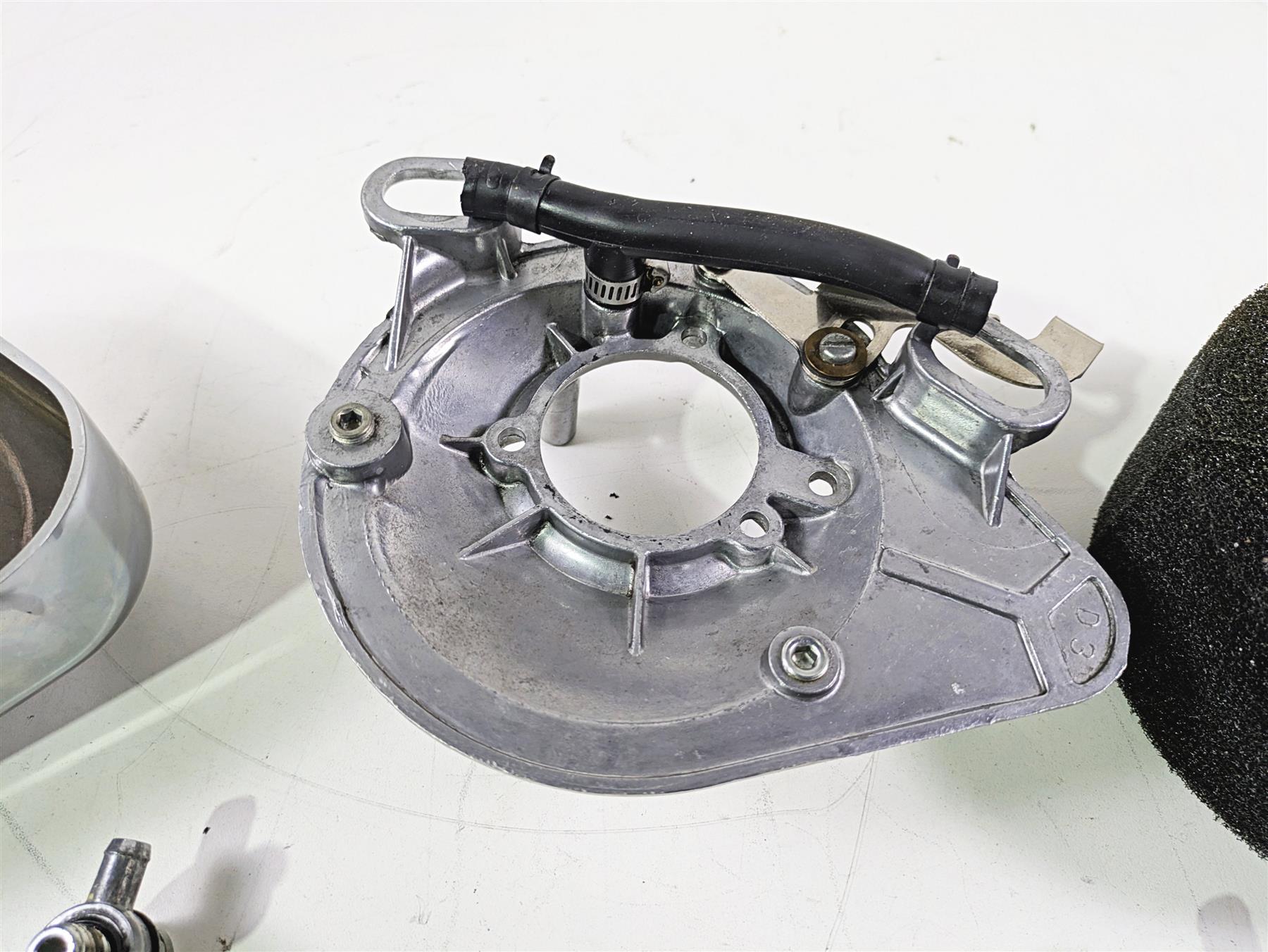 Used aluminum motorcycle engine cover with attached hose, available at Mototech271