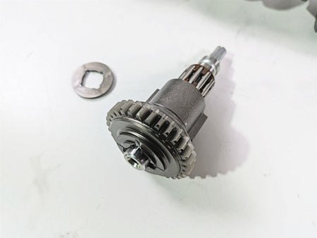 Used motorcycle starter gear and washer on white background, available at Mototech271