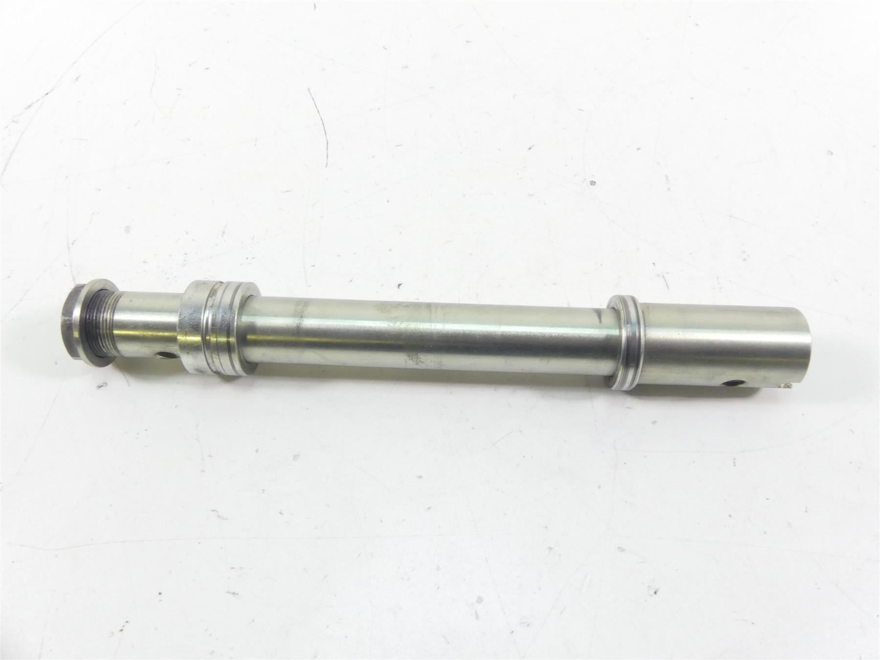 Used motorcycle axle shaft, clean metal part on white background, available at Mototech271