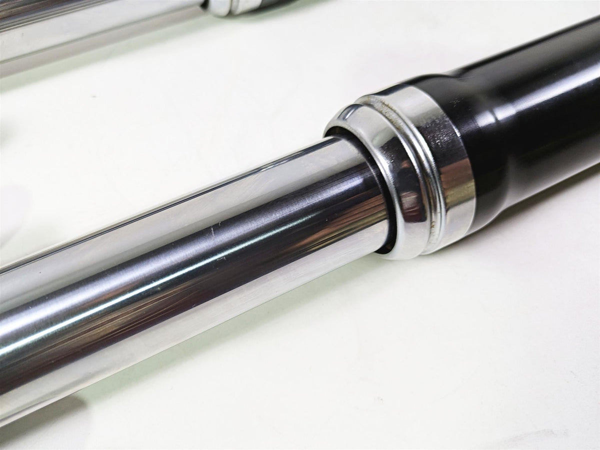 Close-up of used motorcycle front fork suspension part, chrome and black, available at Mototech271