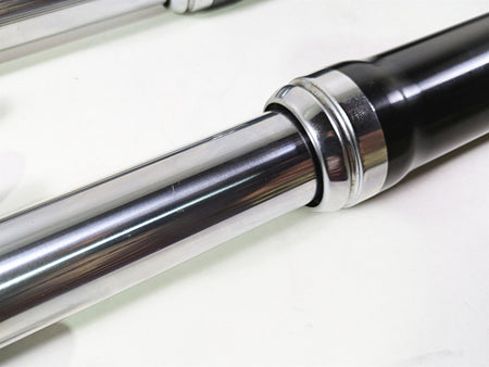 Close-up of used motorcycle front fork suspension part, chrome and black, available at Mototech271