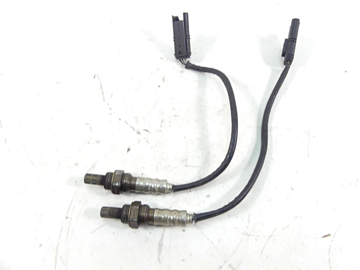Used motorcycle oxygen sensors with wiring and connectors on white background, available at Mototech271
