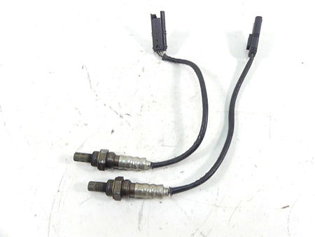Used motorcycle oxygen sensors with wiring and connectors on white background, available at Mototech271
