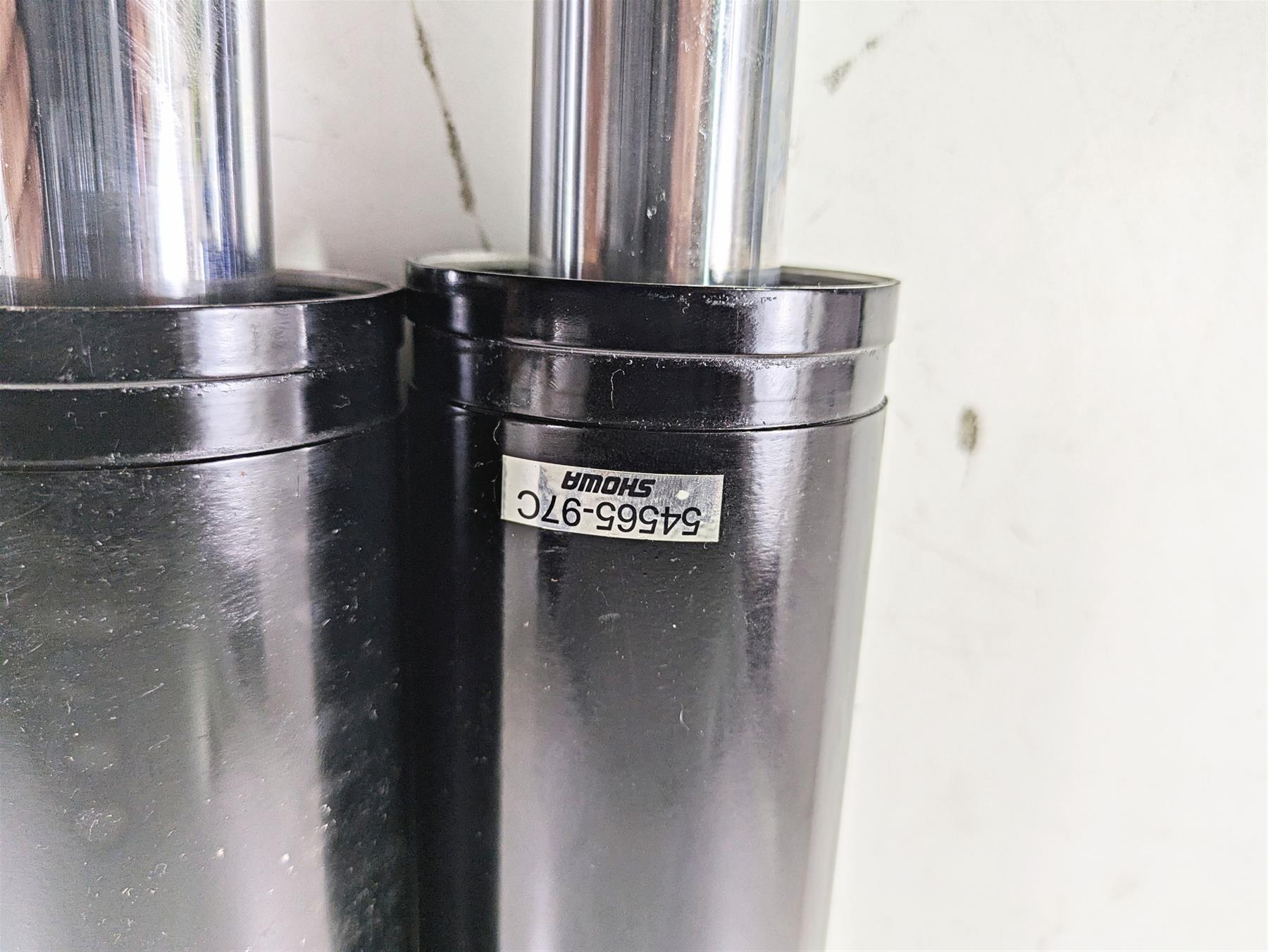 Pair of black Showa motorcycle fork tubes with part number tag available at Mototech271