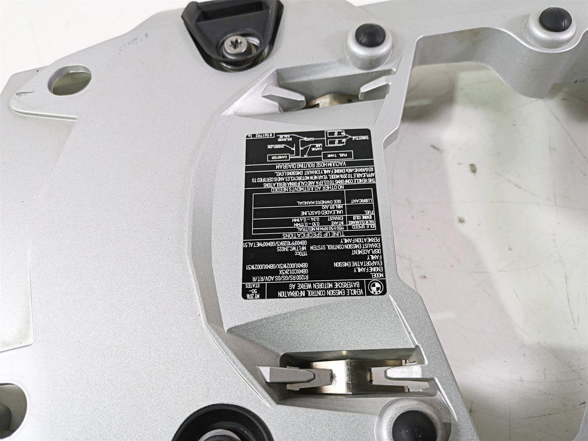 Silver motorcycle part with black label and bolts on white background, available at Mototech271
