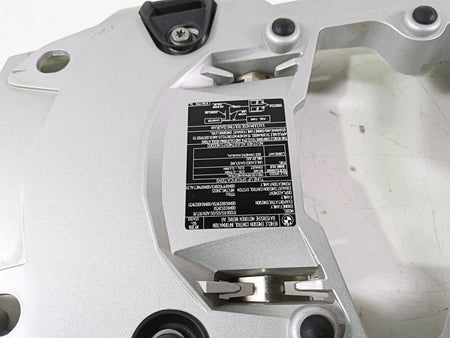 Silver motorcycle part with black label and bolts on white background, available at Mototech271