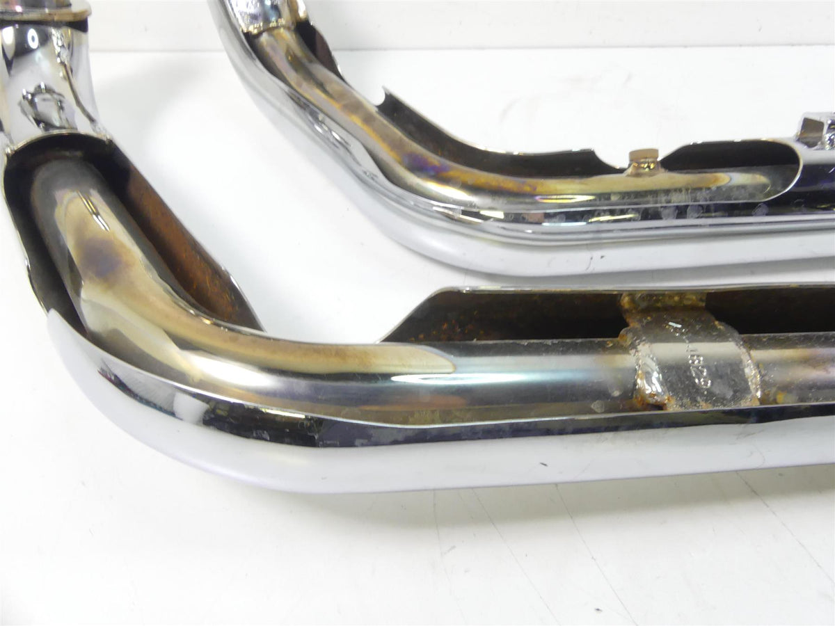 Used chrome motorcycle exhaust pipes with rust and weld marks, available at Mototech271