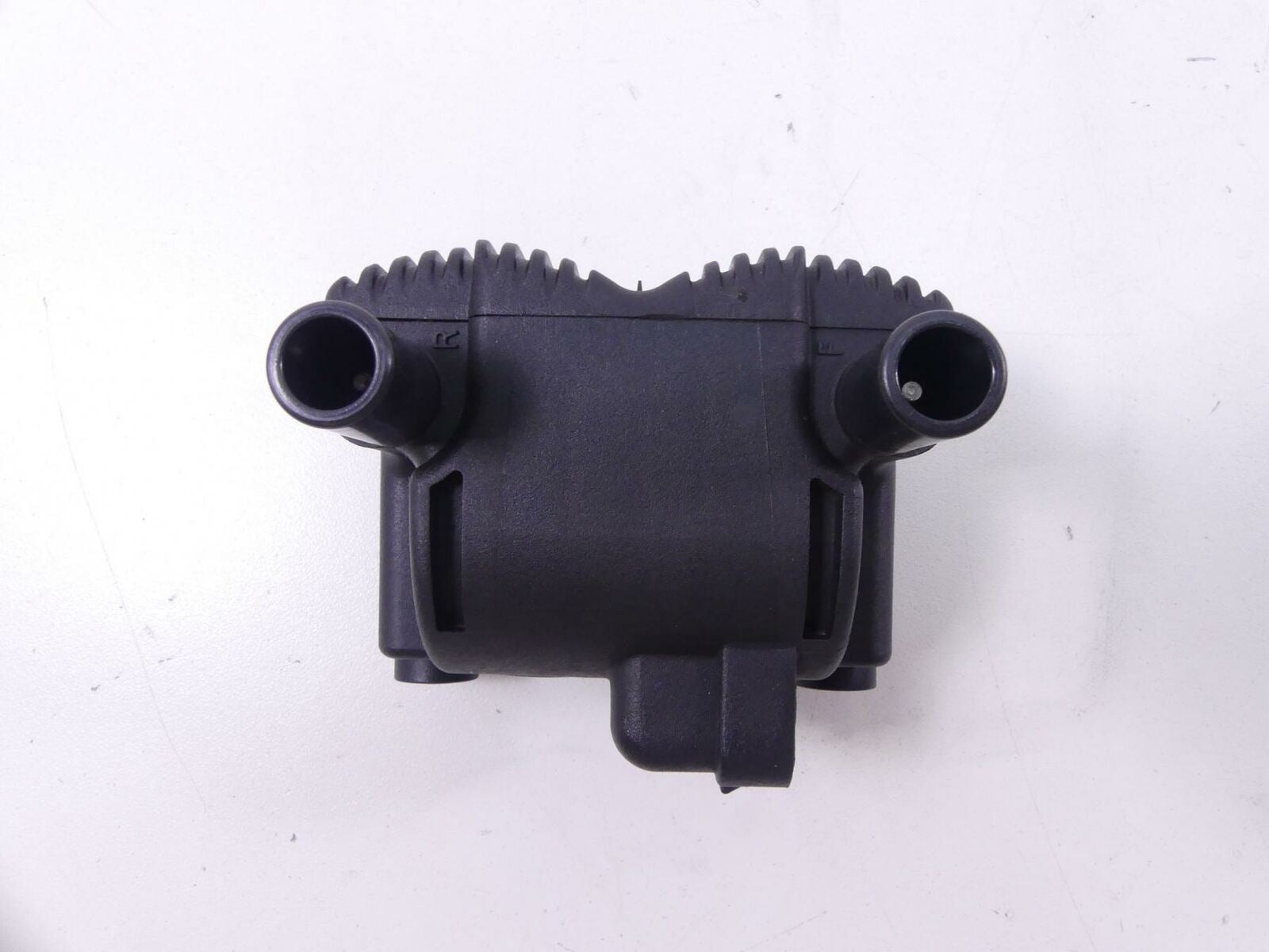 Used motorcycle ignition coil part on white background, available at Mototech271