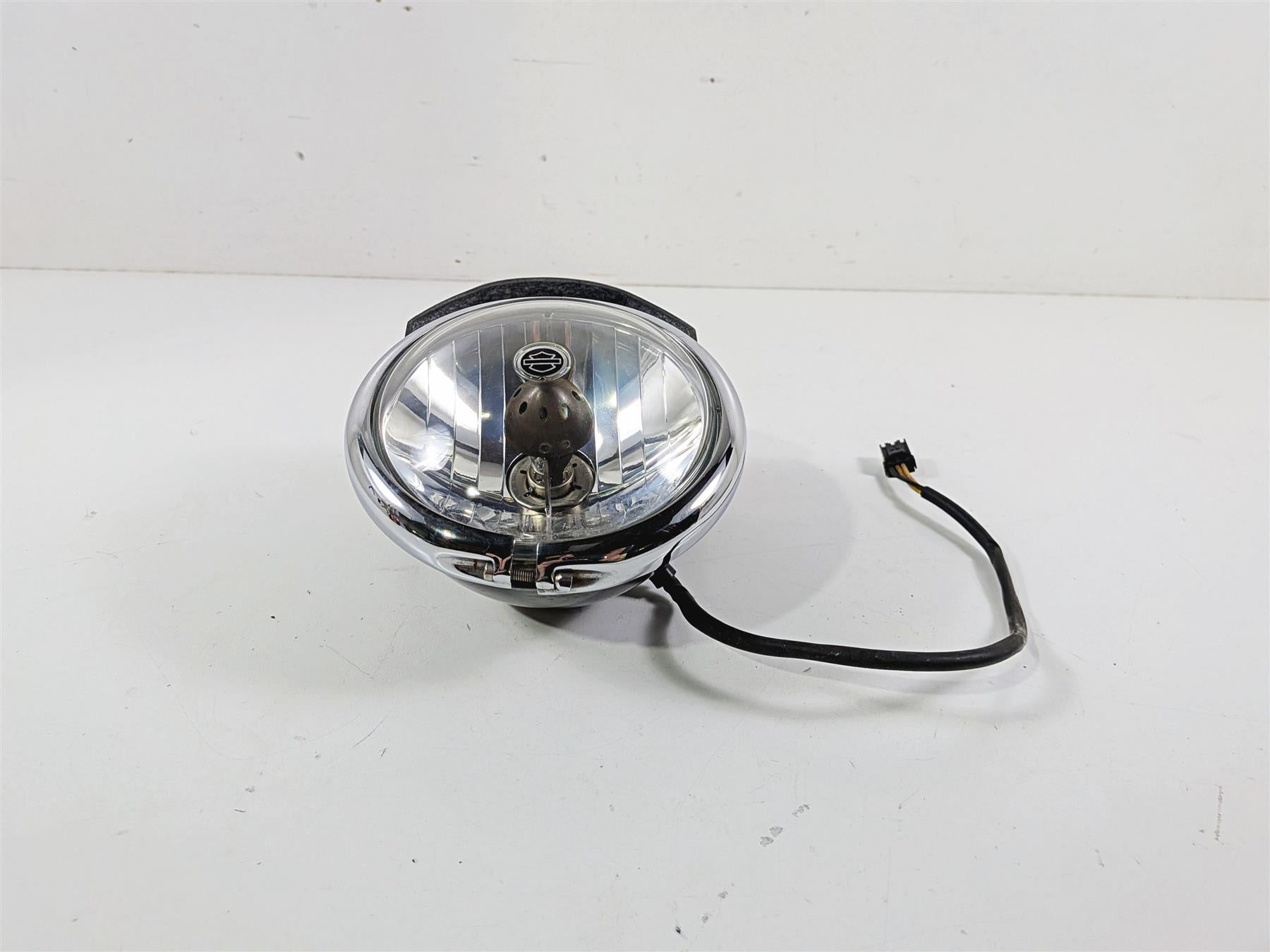 Used Harley-Davidson motorcycle headlight with wiring, chrome housing, available at Mototech271