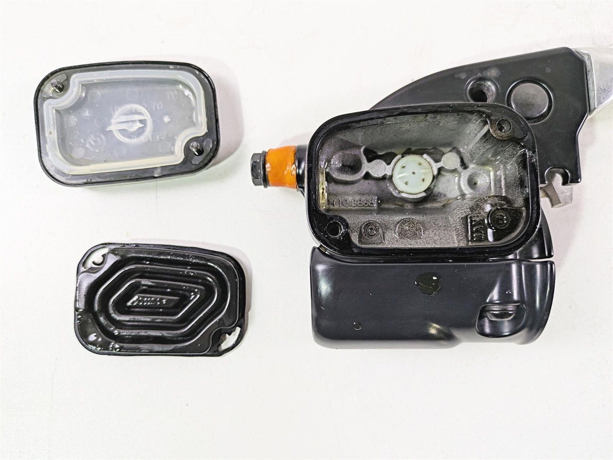 Used motorcycle brake master cylinder reservoir parts on white background, available at Mototech271